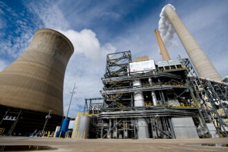 American Electric Power's Mountaineer coal power plant opened a carbon capture unit (center right), alongside the plant's cooling tower and stacks in 2009. The project later died. Credit: Saul Loeb/AFP via Getty Images