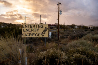 A sign welcomes passersby to an “Energy Sacrifice Zone” outside of Counselor, New Mexico, on Oct. 26, 2021. The Greater Chaco region has become a flashpoint between environmental activists and the oil and gas industry, which is expanding into the oil-rich land. Credit: Jimmy Cloutier/Howard Center for Investigative Journalism
