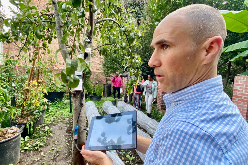 Zaitchik shows the downloaded weather data from a low-cost measurement device planted on a tree. The measurements needs to be manually downloaded to a computer periodically, Zaitchik said during the Old Goucher neighborhood visit. Credit: Aman Azhar/Inside Climate News