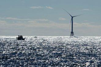 A boat passes one of the wind turbines of the Block Island Wind Farm on Oct. 14, 2016 off the shore of Rhode Island. Credit: Don Emmert/AFP via Getty Images