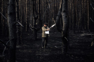 In Chernobyl, a Ukrainian technician in 1998 checked a spot with a Geiger counter in the forest outside the damaged nuclear plant, which burned in a wildfire in 1992, six year after the worst nuclear accident in history. The fire burned 667 acres. As a consequence, the radioactive fallout was released in smoke aerosols and transported various distances while radioactive ashes remained on the site. Credit: Patrick Landmann/Getty Images.