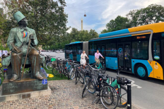 The statue of the author Hans Christian Anderson at City Hall Square in Copenhagen, photographed in August. The city is known for being bike-friendly and this street, Hans Christian Anderson Boulevard, sometimes feels like highway for bicycles. Credit: Dan Gearino/Inside Climate News