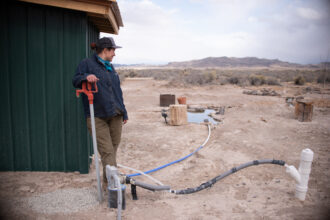 Angie Mestas, a schoolteacher, used a lifetime of savings to drill a drinking well on her land in Los Sauces, Colorado. But she won't drink from it until she tests for arsenic and E. coli, which are common in the area. Credit: Melissa Bailey for KFF Health News