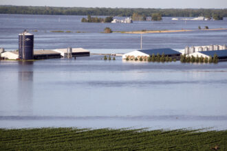 A farm in Iowa is surrounded by flood water. Credit: Scott Olson/Getty Images.