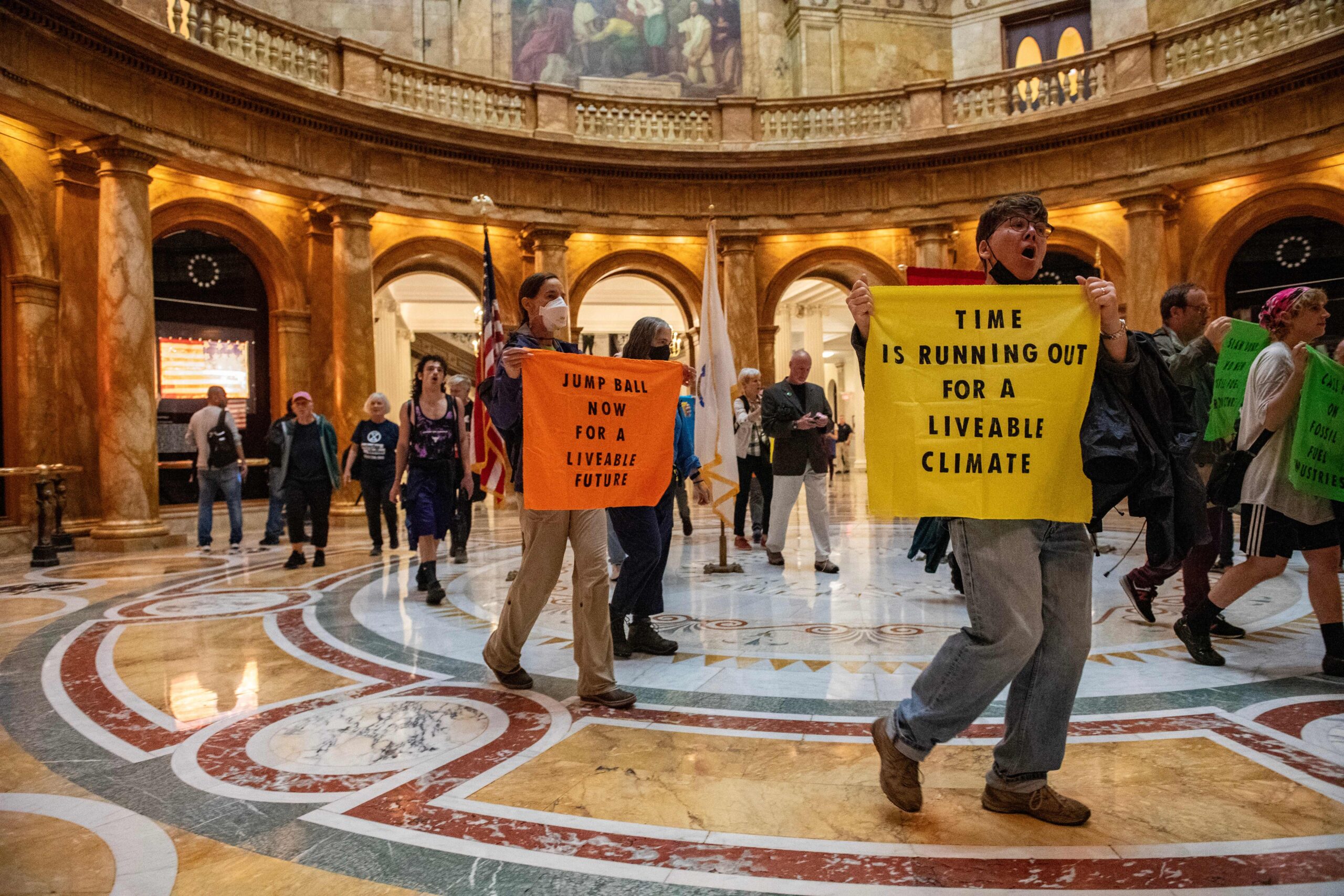 Demonstrators from Extinction Rebellion gather to call on Massachusetts Governor Maura Healy to put a ban on new fossil fuel infrastructure, at the Massachusetts State House in Boston on Sept. 18, 2023. Credit: Joseph Prezioso/AFP via Getty Images