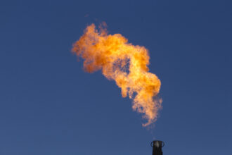 Excess natural gas is burned off in a process known as "flaring" an oil well where it is not economically feasible to capture the gas. Credit: (Photo by Robert Daemmrich Photography Inc/Corbis via Getty Images.