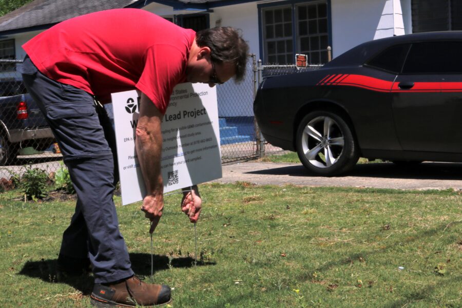 EPA On-Scene Coordinator Chuck Berry fixes a sign on a yard his team cleaned on English Avenue on May 12, 2022. Since 2019, the agency has been testing soil in the study area, which spans more than 600 acres, for lead. Credit: Aydali Campa