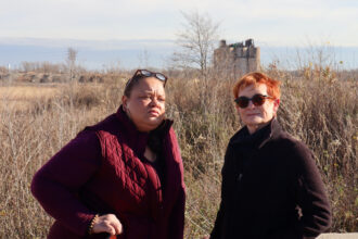 Kimmie Gordon and Dorreen Carey stand in front of a former cement plant site in Gary, Indiana, where a California company, Fulcrum BioEnergy, wants to turn trash and plastic into jet fuel. They are founding members of Gary Advocates for Responsible Development, which opposes the jet fuel plant. Credit: James Bruggers