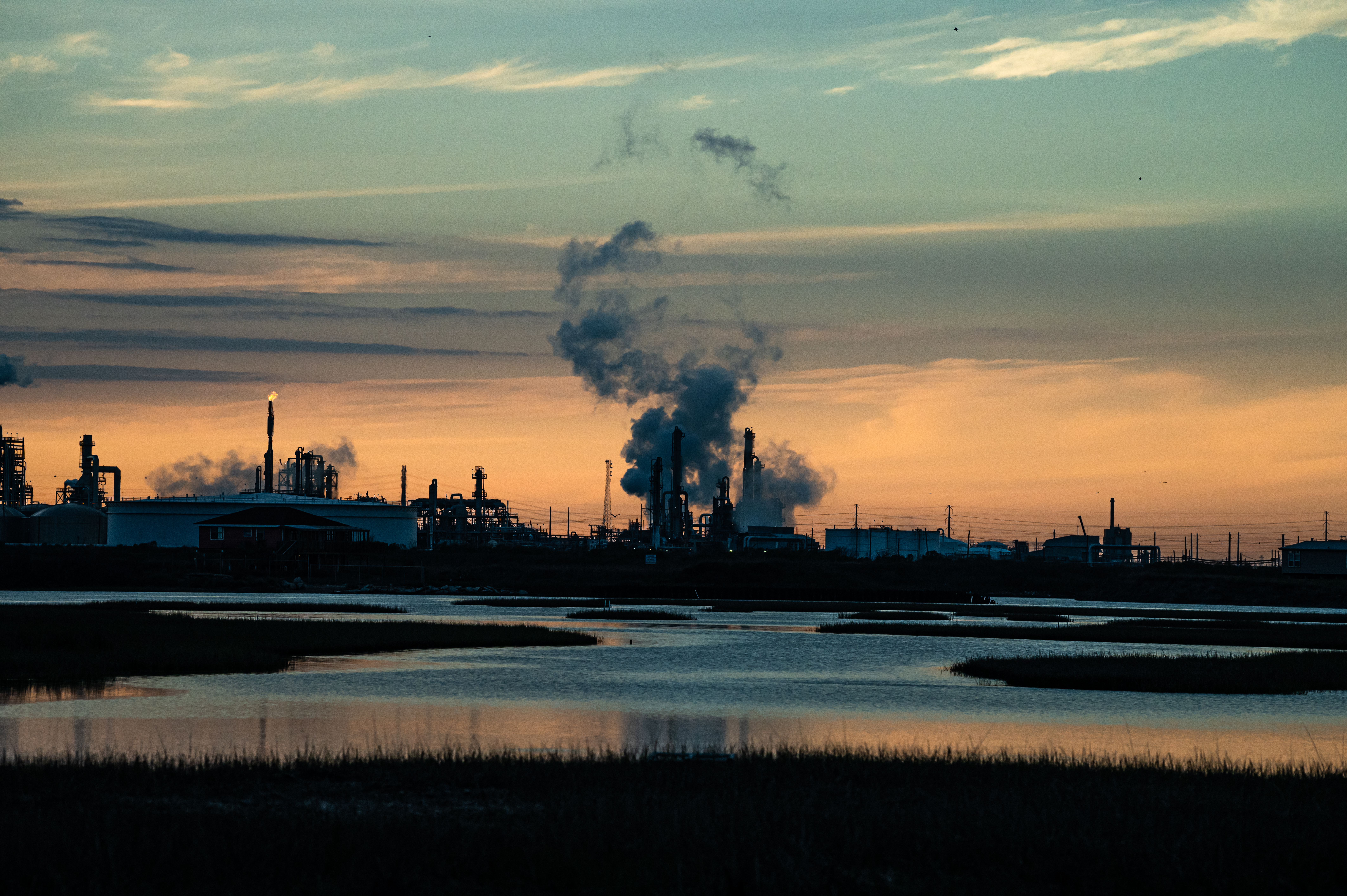 The smokestacks of Dow and other petrochemical plants dominate the skyline in the lower Brazos River watershed around Freeport, Texas. Credit: Meridith Kohut for The Texas Observer.