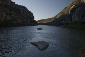 Limestone canyons line the lower Pecos River near its confluence with the Rio Grande. The Pecos flows from New Mexico into the Permian Basin in Texas before eventually flowing into the Amistad Reservoir at the Rio Grande. The river has been discussed as a potential target for produced water discharges. Credit: Robert Daemmrich Photography Inc/Corbis via Getty Images.