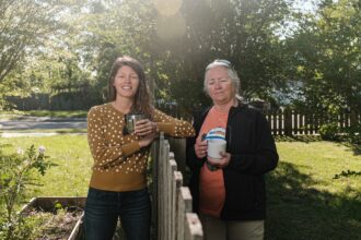 Neighbors Kelly Hagen (left) and Dixie Wilkinson stand in their respective yards on April 22, 2021 in Pensacola, Florida. Their homes are located next to the now closed American Creosote Works, now an EPA Superfund site which is causing environmental problems for the area and health problems for the residents who live near it. Credit: Dan Anderson