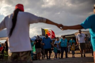 People dance together at the protest camp at Thacker Pass, Nevada on Sunday, Sept. 12, 2021. Earlier in the day People of Red Mountain organized a remembrance of a massacre of indigenous people nearby on the same date in 1865. Credit: Spenser Heaps
