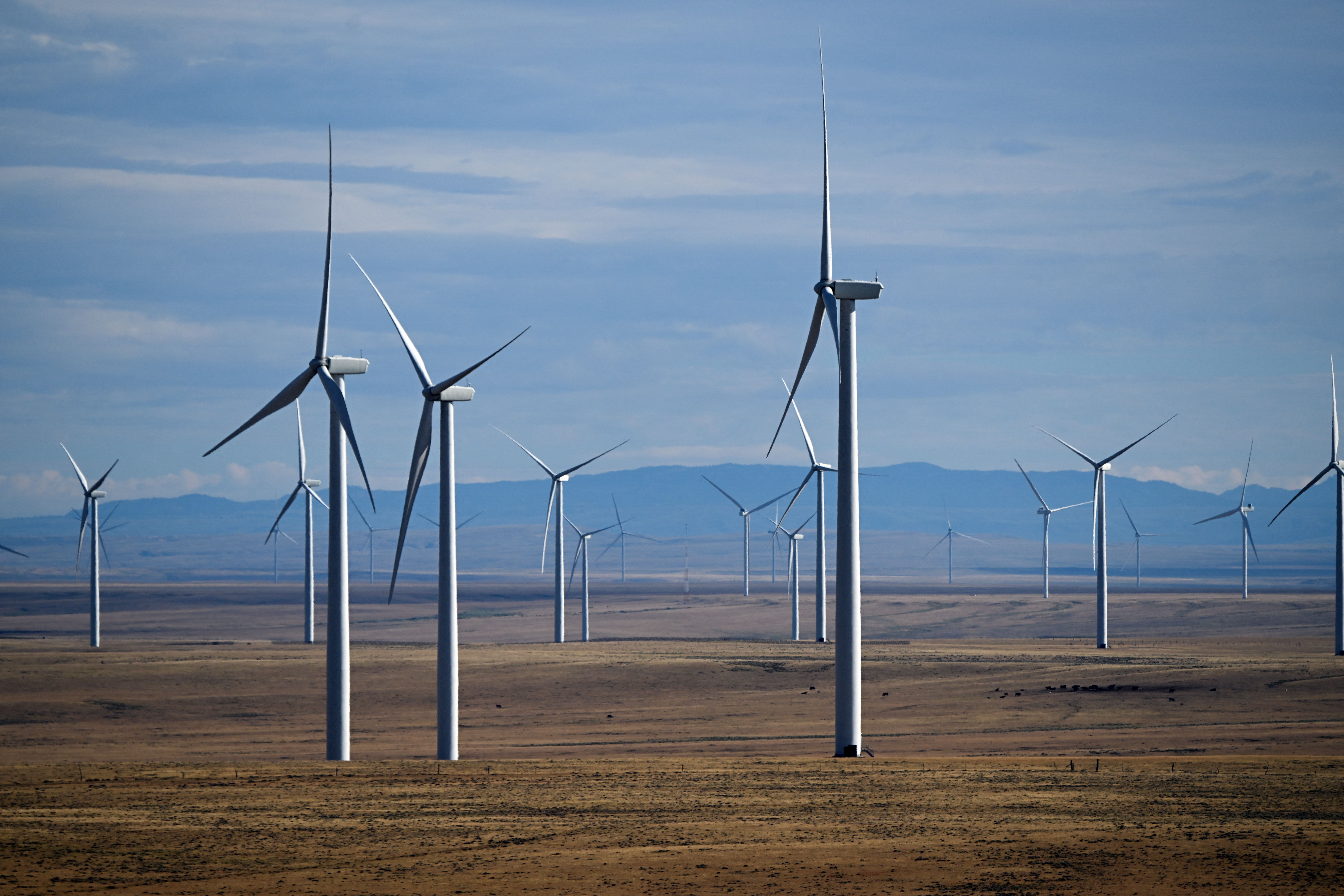 Wind electric power generation turbines generate electricity outside Medicine Bow, Wyoming in August 2022. Credit: Patrick T. Fallon/ AFP via Getty Images.