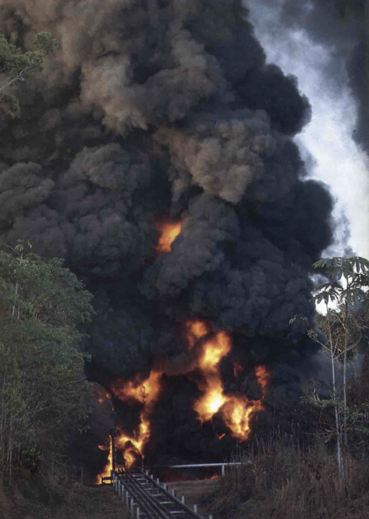An open fire at a waste pit in Cuyabeno Wildlife Preserve in the Ecuadorian Amazon rainforest. Photo originally published in Kimerling's Amazon Crude. Credit: courtesy of Judith Kimerling