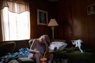 Kimberly Laskowsky sits in her living room in Marianna, Washington County, approximately 850 feet from EQT's Gahagan well pad.